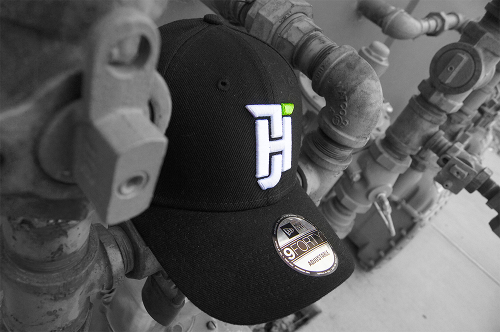 Black cap against industrial pipe background